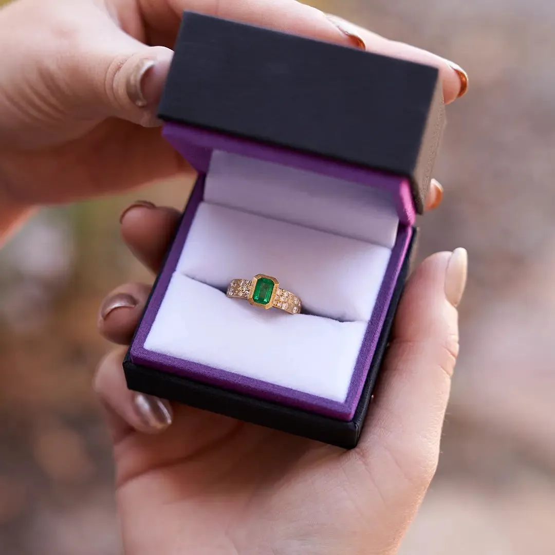 Bezel Set Emerald-Cut Emerald in Yellow Gold with Flush Set Diamond Band
